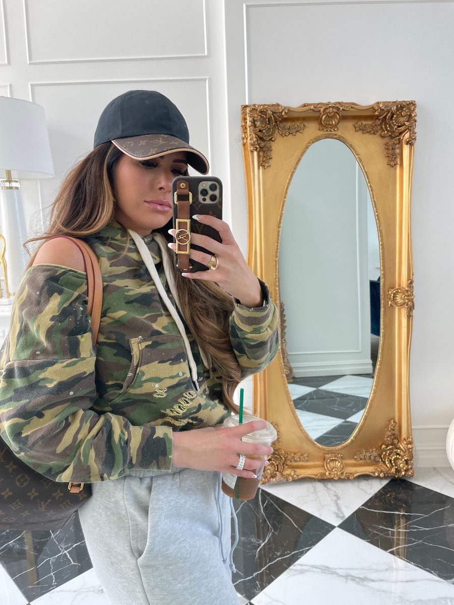 Emily Ann Gemma, Camo Sweatshirt, Sweatpants Outfit, Louis Vuitton Ballcap, Louis Vuitton Backpack |  Instagram Recap by popular US life and style blog, The Sweetest Thing: image of Emily Gemma wearing a camo cold shoulder hoodie sweatshirt, black and brown Louis Vuitton baseball cap, and grey jogger sweatpants. 
