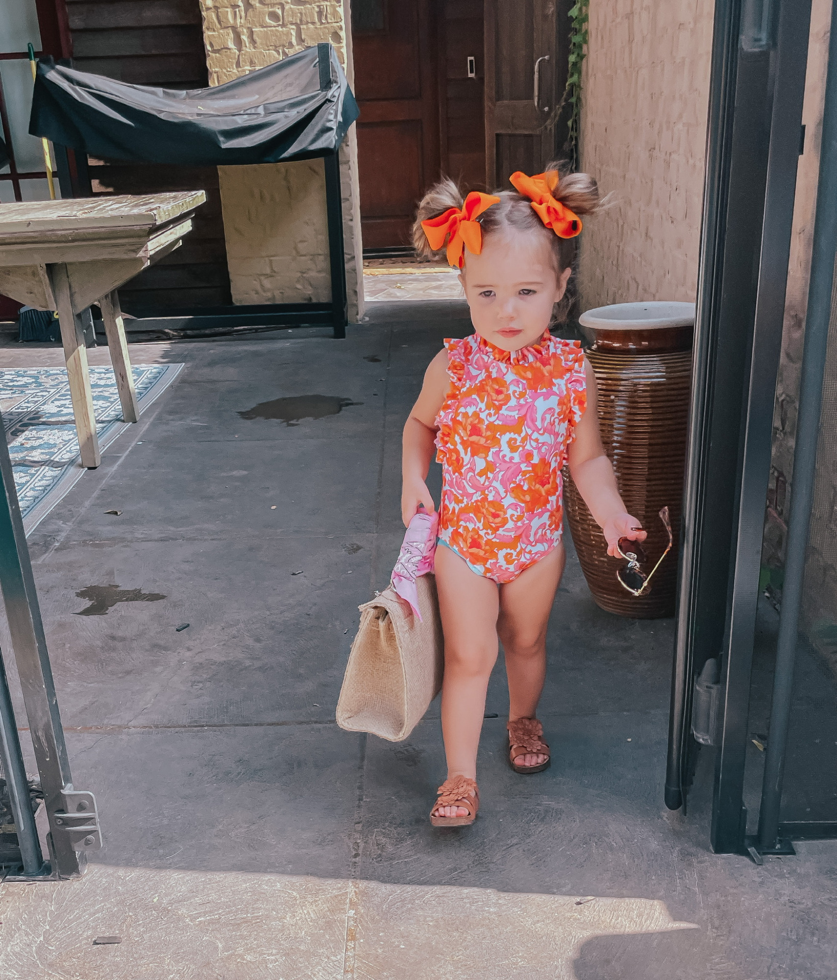 Sophia Gemma, Toddler Swimsuit, Toddler Bows, Swimwear for little girls, Kids Sunglasses, Baby Girl Summer Outfit Ideas | Instagram Recap by popular US life and style blog, The Sweetest Thing: image of Sophie wearing a Janie and Jack swimsuit, Zara sandals, orange hair bows and holding a woven handbag from Etsy. 