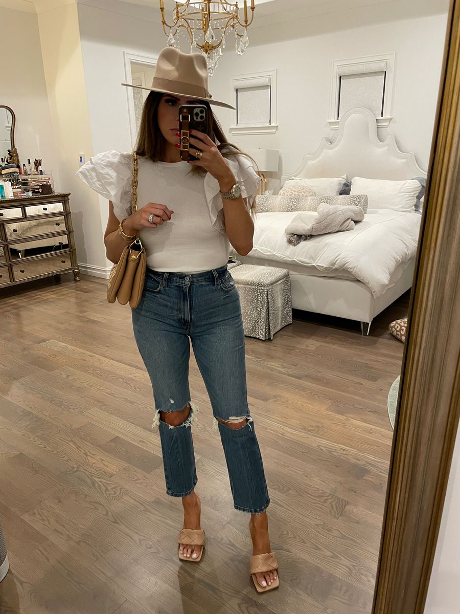Emily Ann Gemma, Casual outfit ideas, pre-fall jeans, nude heels, Louis Vuitton coussin handbag , Ruffle sleeve bodysuit |  Instagram Recap by popular US life and style blog, The Sweetest Thing: image of Emily Gemma wearing a white ruffle sleeve bodysuit, distressed jeans, tan braided strap sandals, tan felt rancher hat, and tan quilted handbag. 