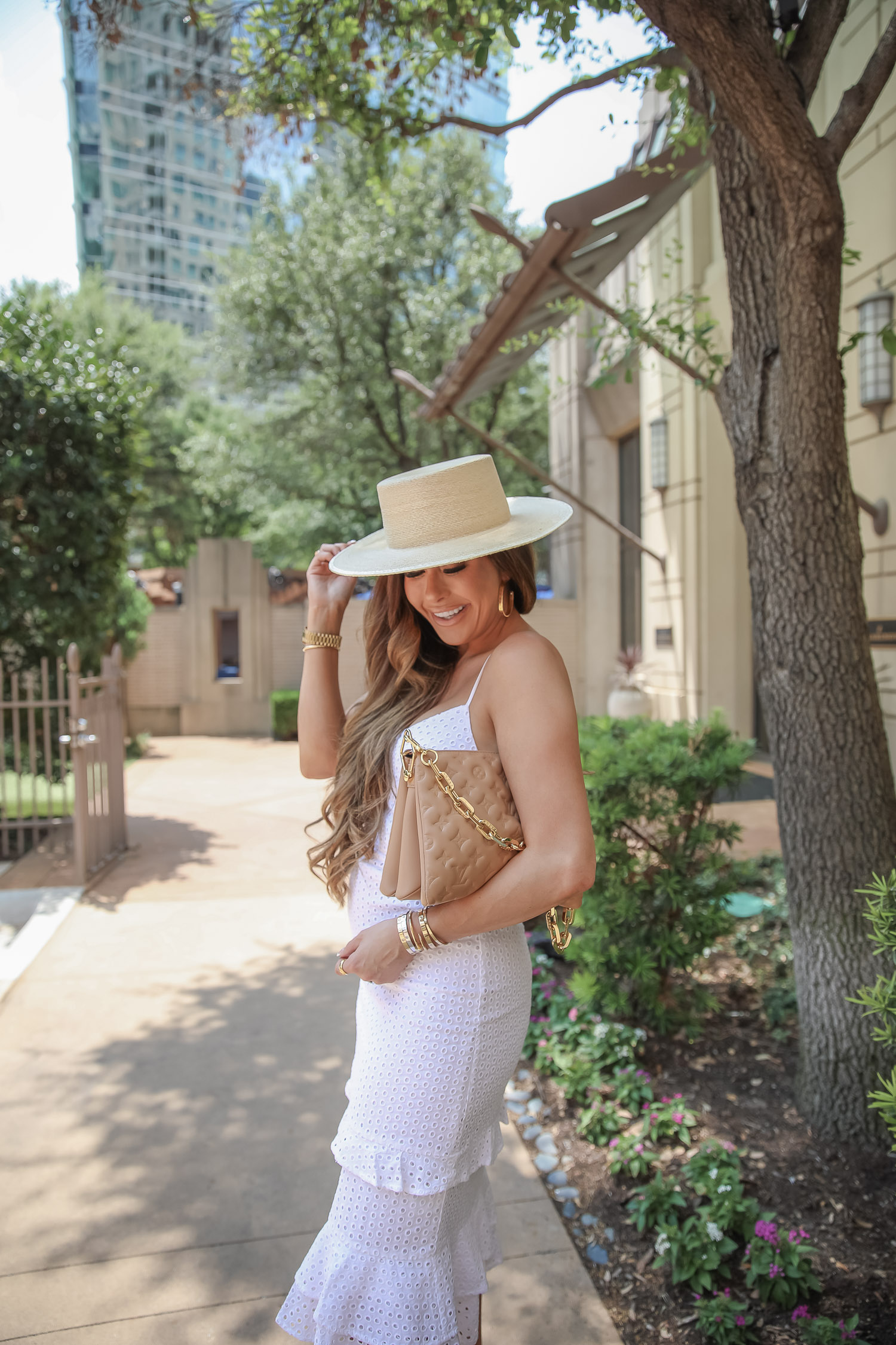 louis vuitton Coussin PM tan 2021, retrofete denim jacket puff sleeve, express fashion 2021, express summer outfits white eyelet dress 2021, emily gemma, | White Eyelet Dress by popular US fashion blog, The Sweetest Thing: image of Emily Gemma wearing a Express white eyelet Dress, tan strap sandals, straw boater hat, and holding a tan hand bag.
