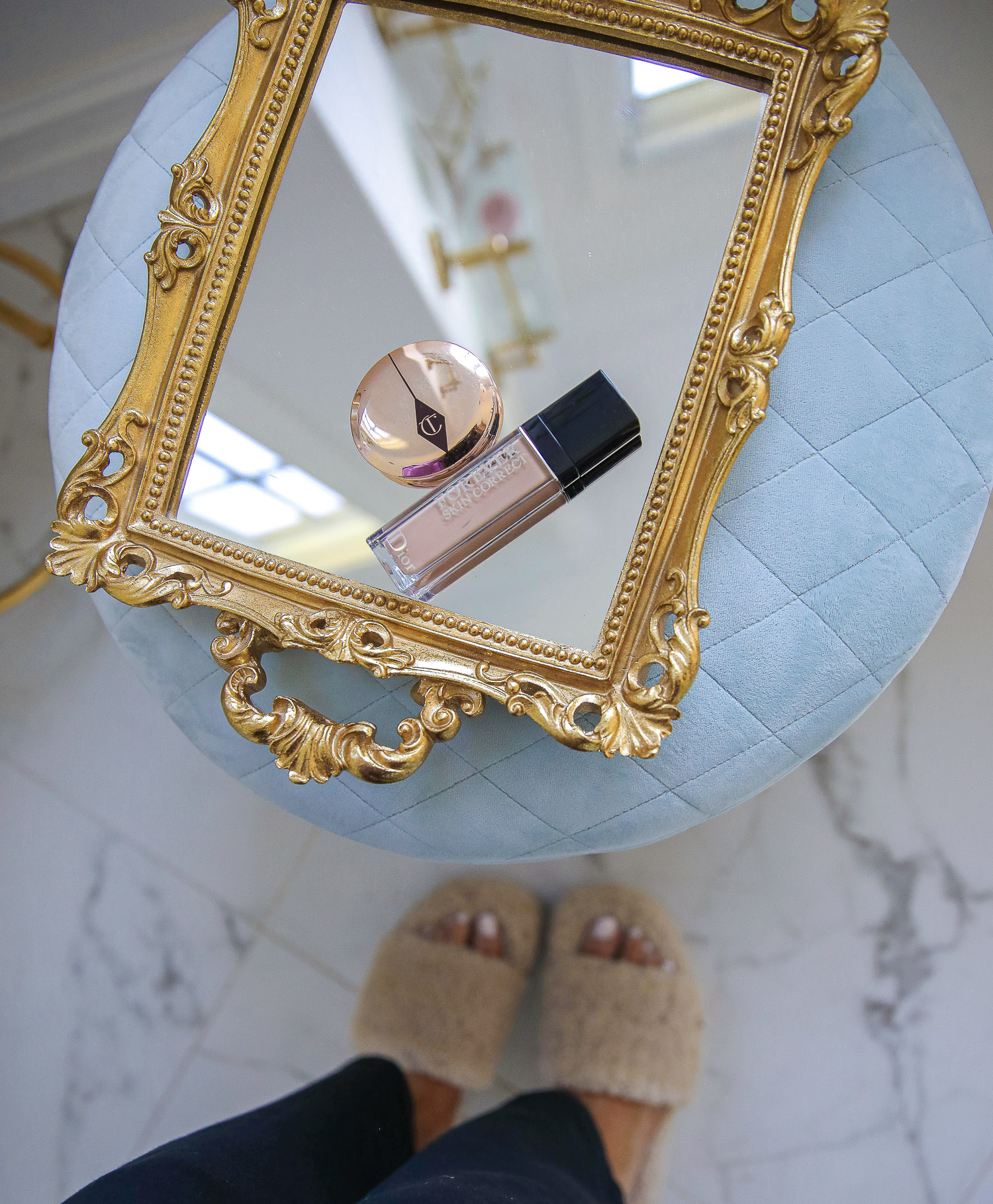 nordstrom beauty must haves fall 2021, sisley pore minimizer review, sisley blur powder review, sisley hyaluronic acid, emily gemma beauty must haves, hoola bronzer palette | Beauty Favorites by popular US beauty blog, The Sweetest Thing: image of a bottle of foundation and a bronzer compact on a mirrored gold frame tray.