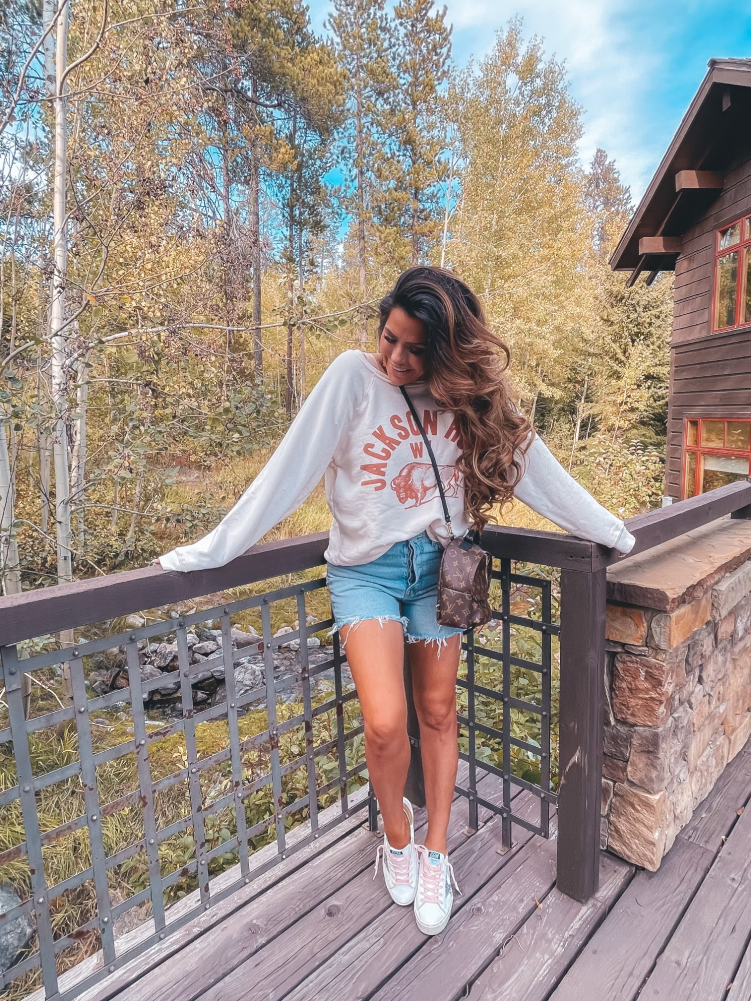 Free People Jackson Hole Sweatshirt, Golden Goose Hi Star Low Top Platform Sneaker, Agolde Parker Long Jean Shorts, Louis Vuitton Monogram Palm Springs Backpack Mini, Fall Outfit Ideas, Graphic Sweatshirt, Wyoming Sweatshirt, Mom and Son Photo, Emily Ann Gemma