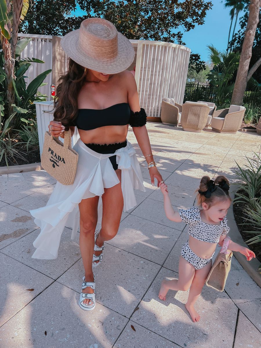 Kinda 3D Diva 3D Tulle Bandeau Two-Piece Bikini Set, Waimari Flamenco Wrap Skirt in White, Chanel Boy Sandals, Lack of Color Boater Hat, Prada Straw Beach Tote, Emily Ann Gemma